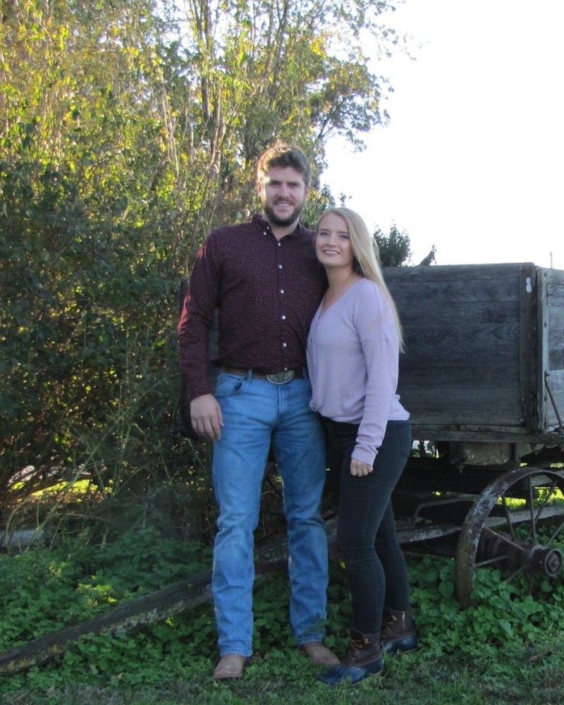 Mitchell and Miranda by an old wagon